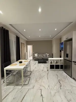 a living room with a white table and a couch at Urban Luxy Staycation in Athens