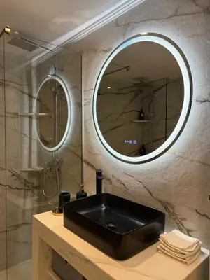 a bathroom with a black sink and a mirror at Urban Luxy Staycation in Athens