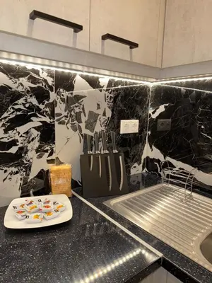 a kitchen with a counter top with a sink and a counter sidx sidx at Urban Luxy Staycation in Athens