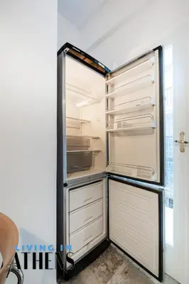 an empty refrigerator with its door open at Spacious Familly Apt Next To Acropolis And Museum 4&1 in Athens