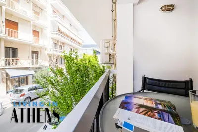 a balcony with a table with a laptop on it at Spacious Familly Apt Next To Acropolis And Museum 4&1 in Athens