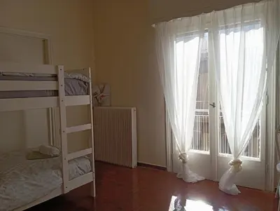 a bedroom with a bunk bed and a window at 4 Single beds room 5' from metro in Athens