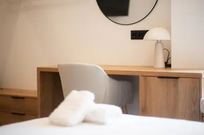 a room with a desk and a chair and a mirror at Megaro Luxury Suite 11 in Syntagma in Athens