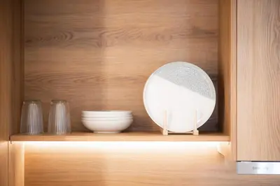 a cabinet with a plate and bowls on a shelf at Megaro Luxury Suite 11 in Syntagma in Athens