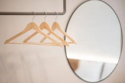 a pair of wooden hangers in front of a mirror at Megaro Luxury Suite 11 in Syntagma in Athens