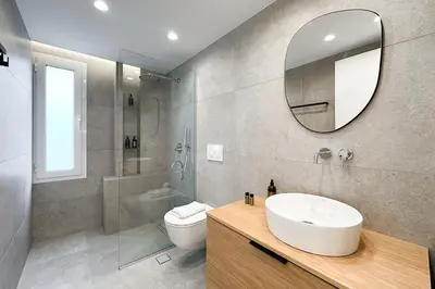 a bathroom with a sink and a toilet and a mirror at Megaro Luxury Suite 11 in Syntagma in Athens