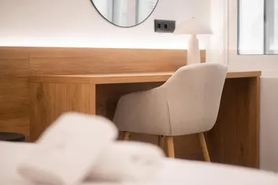a chair sitting next to a desk with a mirror at Megaro Luxury Suite 7 in Syntagma in Athens