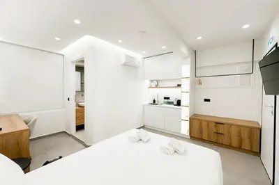 a white kitchen with two beds in a room at Megaro Luxury Suite 7 in Syntagma in Athens