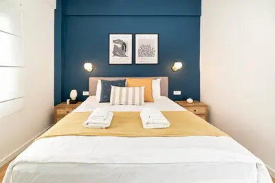 a bedroom with a large bed with blue walls at Beautiful Apartment in the most Iconic area in Athens in Athens