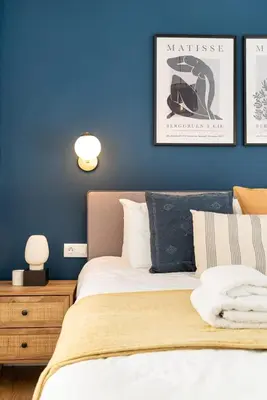 a bedroom with a bed and a blue wall at Beautiful Apartment in the most Iconic area in Athens in Athens