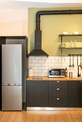 a kitchen with a refrigerator and a microwave at Beautiful Apartment in the most Iconic area in Athens in Athens
