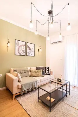 a living room with a couch and a table at Beautiful Apartment in the most Iconic area in Athens in Athens