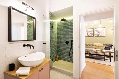 a bathroom with a sink and a glass shower at Beautiful Apartment in the most Iconic area in Athens in Athens
