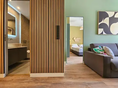 a room with a partition with a couch and a bedroom at Acropolis Panorama Suite by YHA in Athens