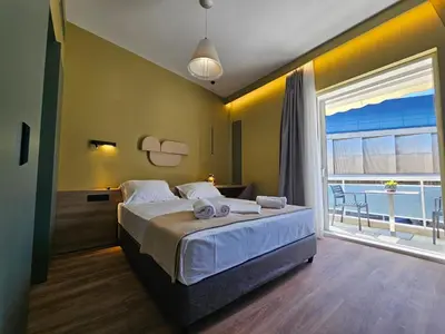a bedroom with a large bed and a large window at Acropolis Panorama Suite by YHA in Athens