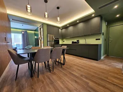 a kitchen and dining room with a table and chairs at Acropolis Panorama Suite by YHA in Athens