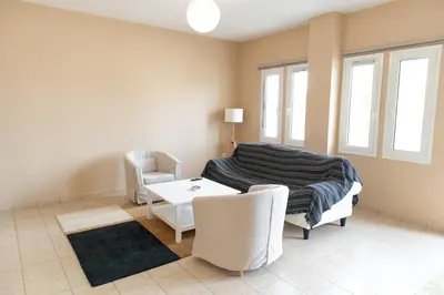 a bedroom with a bed and a table and chairs at Airport city center in Spáta