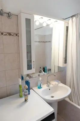 a bathroom with a sink and a mirror at Airport city center in Spáta