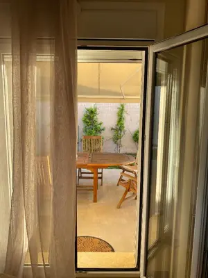a view of a dining room table from a window at Serenity Residence in Anavissos