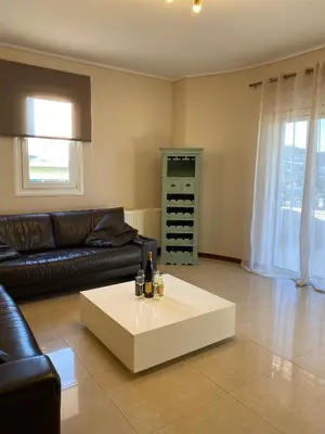 a living room with a couch and a coffee table at Serenity Residence in Anavissos
