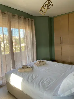 a bedroom with a bed with two towels on it at Serenity Residence in Anavissos