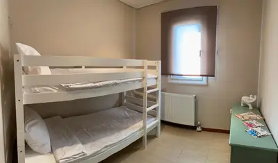 two bunk beds in a room with a window at Serenity Residence in Anavissos