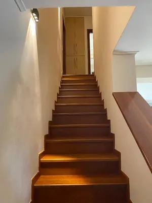 a stairway with wooden steps and a building at Serenity Residence in Anavissos