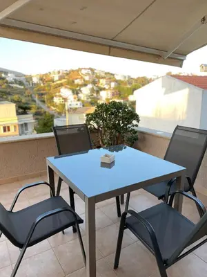 a blue table and chairs on a balcony at Serenity Residence in Anavissos