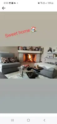 a living room with a couch and a fireplace at ATHEN'S riviera apartment Acropolis view in Athens