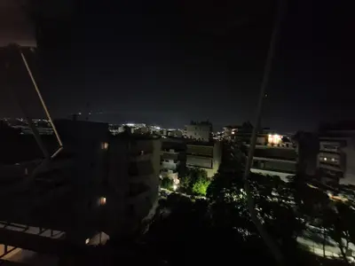 a view of a city at night at ATHEN'S riviera apartment Acropolis view in Athens