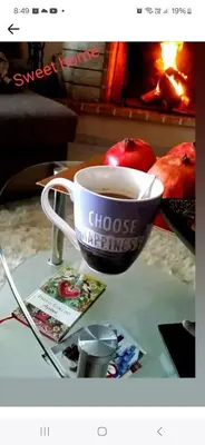 a cup of coffee on a table next to a fireplace at ATHEN'S riviera apartment Acropolis view in Athens