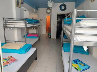 a dorm room with three bunk beds in it at Acropolis views in Monastiraki square in Athens