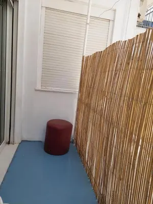 a room with a red stool next to a fence at Acropolis views in Monastiraki square in Athens