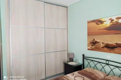 a bedroom with a large sliding closet door at Comfortable Apartment in the Center of Piraeus in Piraeus