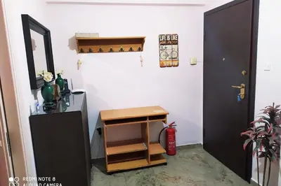 a room with a door and a table and a shelf at Comfortable Apartment in the Center of Piraeus in Piraeus