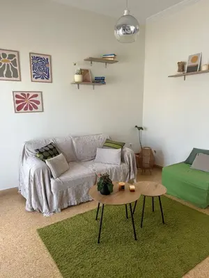a living room with a couch and a table at Aegean Light Flat near Metro in Athens