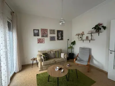 a living room with a couch and a table at Aegean Light Flat near Metro in Athens
