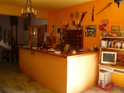 a restaurant with a counter with a computer on it at Liberty II in Agia Marina Aegina