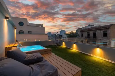 a rooftop patio with a hot tub on a roof at The Industrial Loft - Private Rooftop & Jacuzzi in Athens