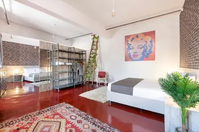 a bedroom with a bed and a book shelf at The Industrial Loft - Private Rooftop & Jacuzzi in Athens