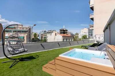 a hot tub on the roof of a building at The Industrial Loft - Private Rooftop & Jacuzzi in Athens