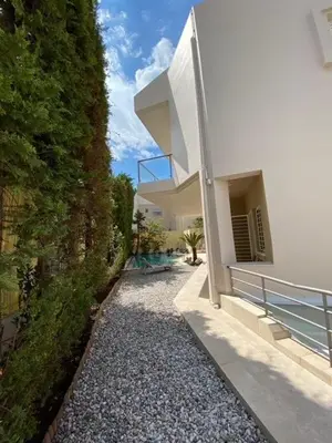 a house with a walkway next to a building at Elegant, villa with pool in Athens Riviera in Athens