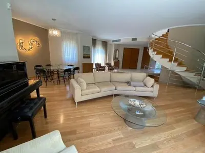 a living room with a white couch and a piano at Elegant, villa with pool in Athens Riviera in Athens