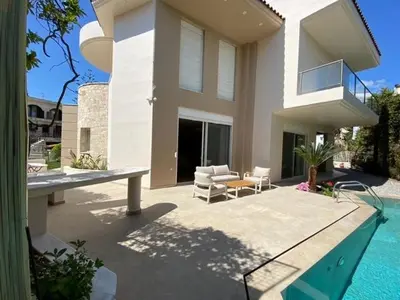 a house with a swimming pool in front of a house at Elegant, villa with pool in Athens Riviera in Athens