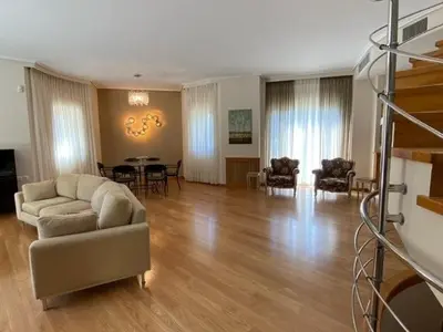 a living room with a couch and a table at Elegant, villa with pool in Athens Riviera in Athens
