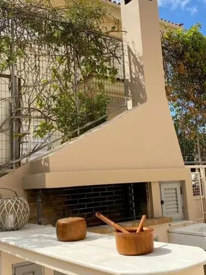 a kitchen with a fireplace with two wooden bowls at Elegant, villa with pool in Athens Riviera in Athens