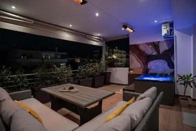 a living room with a couch and a table at One-Bedroom Jacuzzi Glyfada in Athens