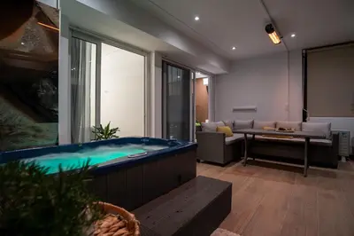 a living room with a large tub in the middle at One-Bedroom Jacuzzi Glyfada in Athens
