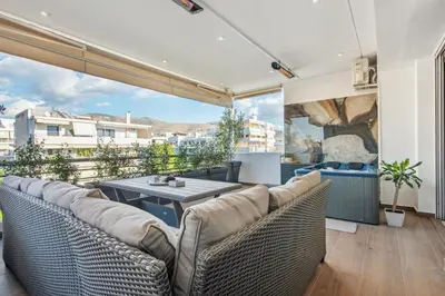 a living room with a couch and a table at One-Bedroom Jacuzzi Glyfada in Athens