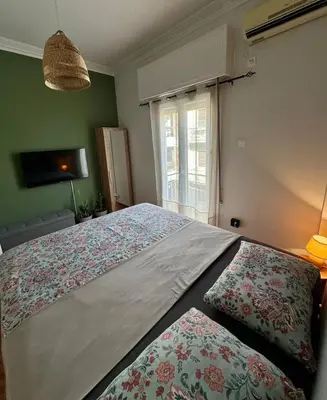 a bedroom with a large bed and a window at Athens Harmony in Athens